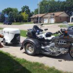 A motorcycle and a white cargo trailer