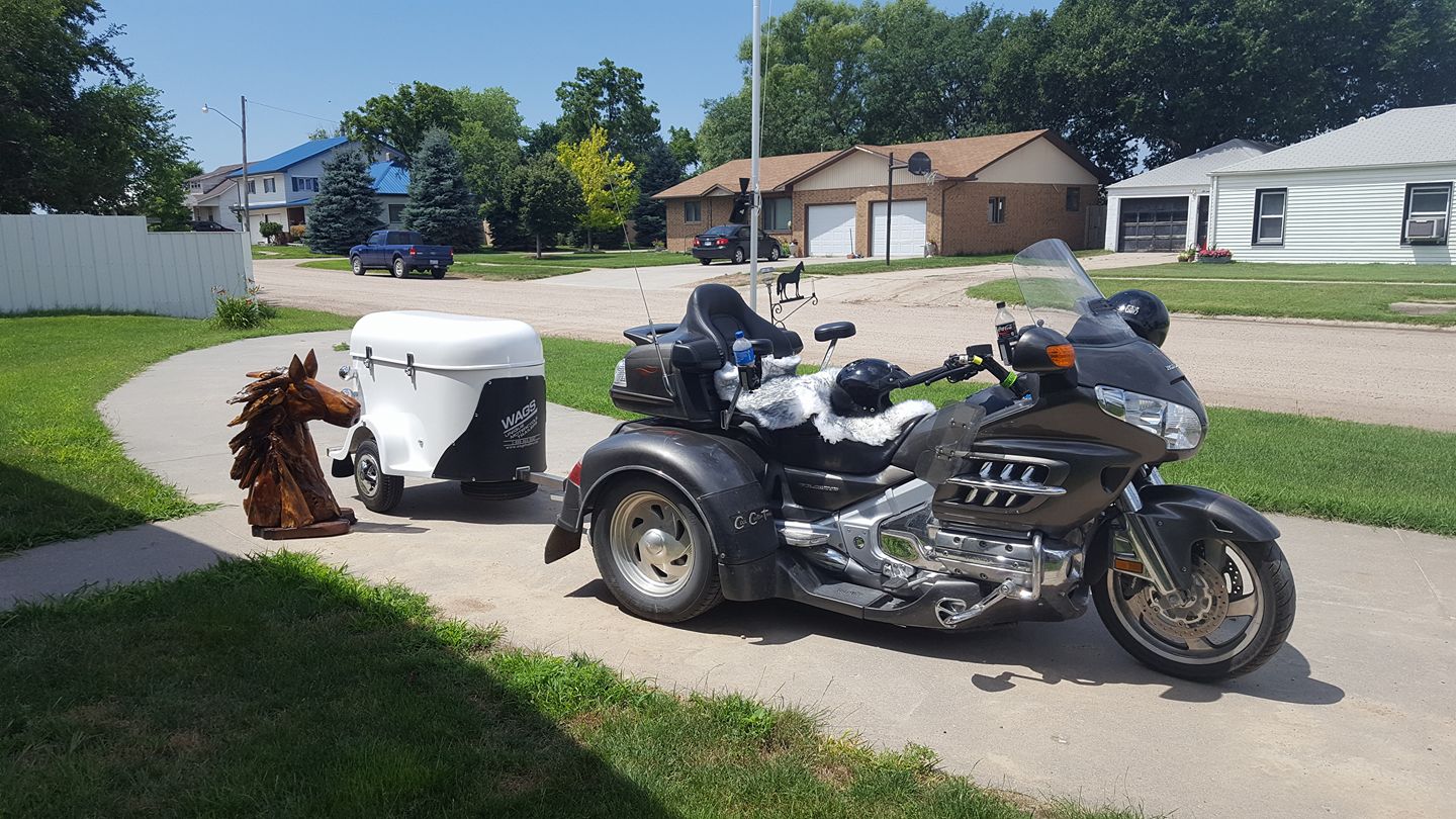 A motorcycle and a white cargo trailer