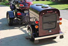 A brown wagon and a black pet trailer