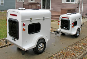 Two white pet trailers